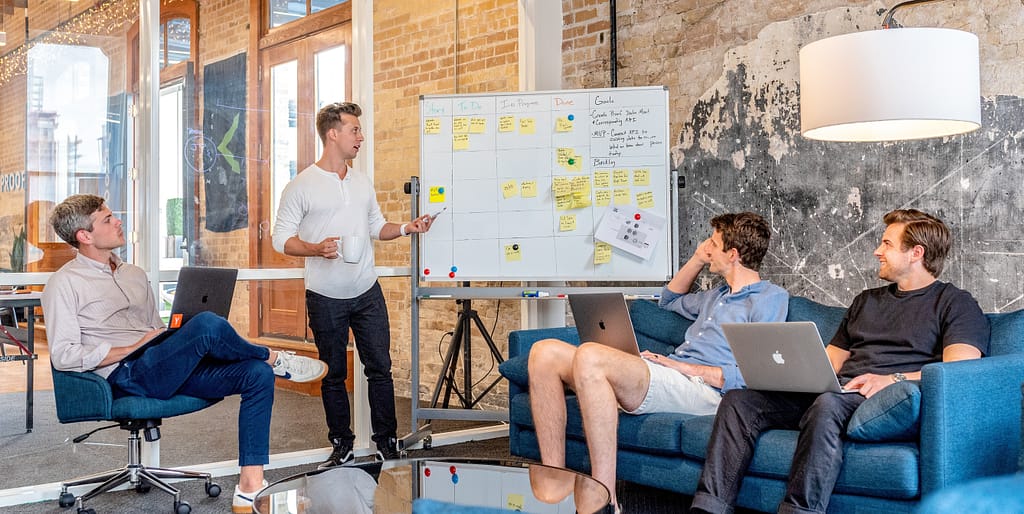 Photo of a team working with their manager, like the C# methods we create work with the int main method